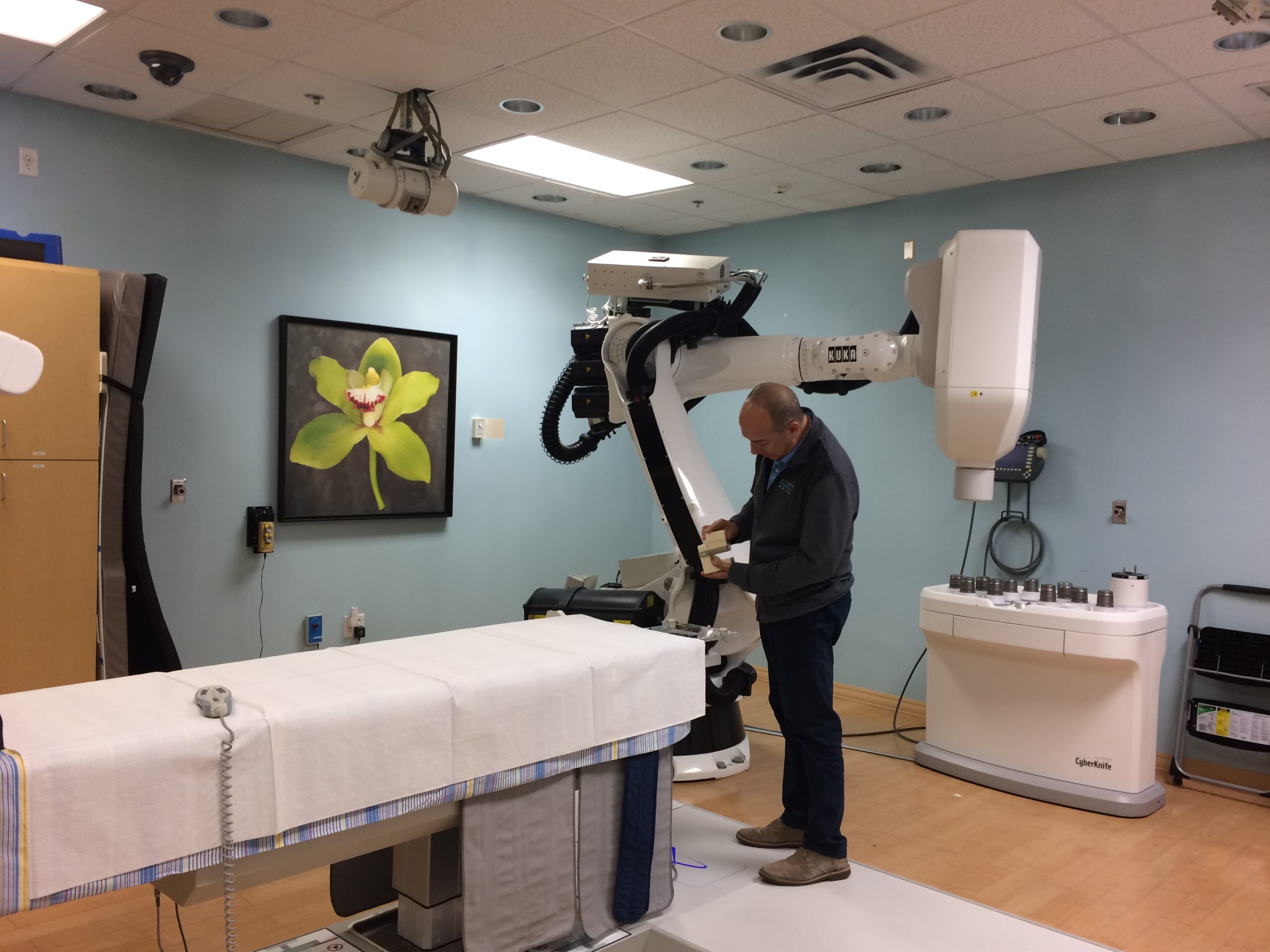 Man working on CyberKnife machine cyberknife miami - alternative cancer treatment - cancer treatment in south florida